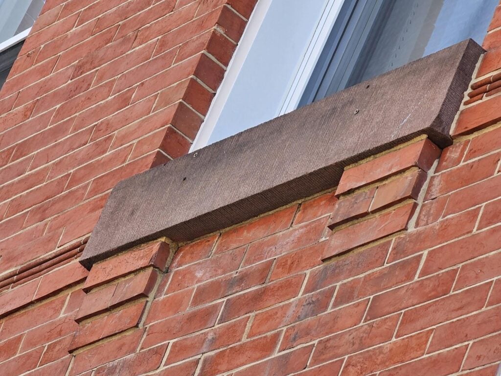 rustic wooden corbels beneath window ledge