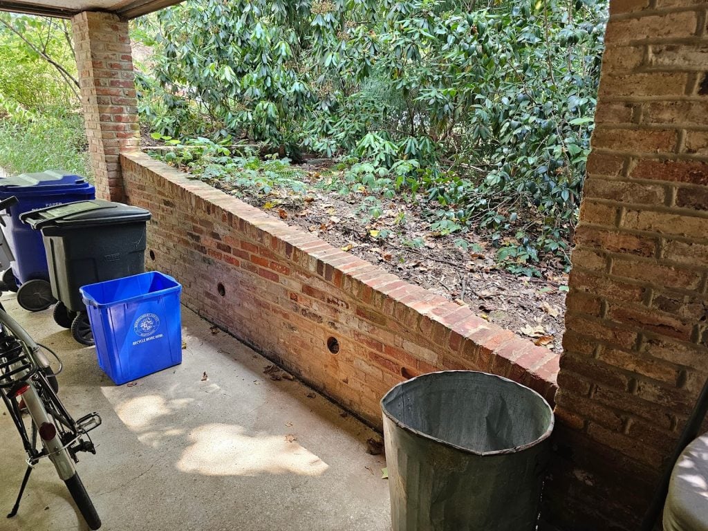 Clogged retaining wall weeps leading to structural damage