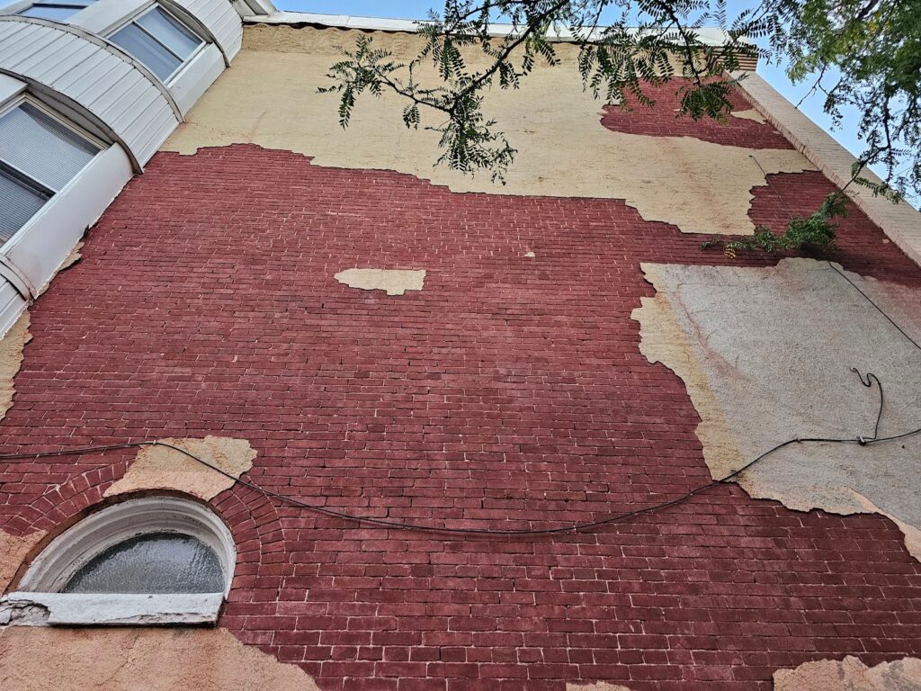 Stucco delaminating over historic brick restoration in Washington, DC