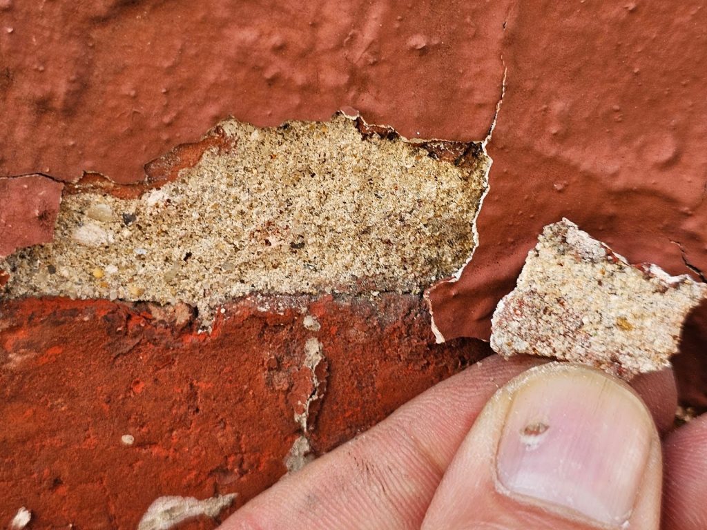 Cracked mortar joints caused by deteriorating paint layers