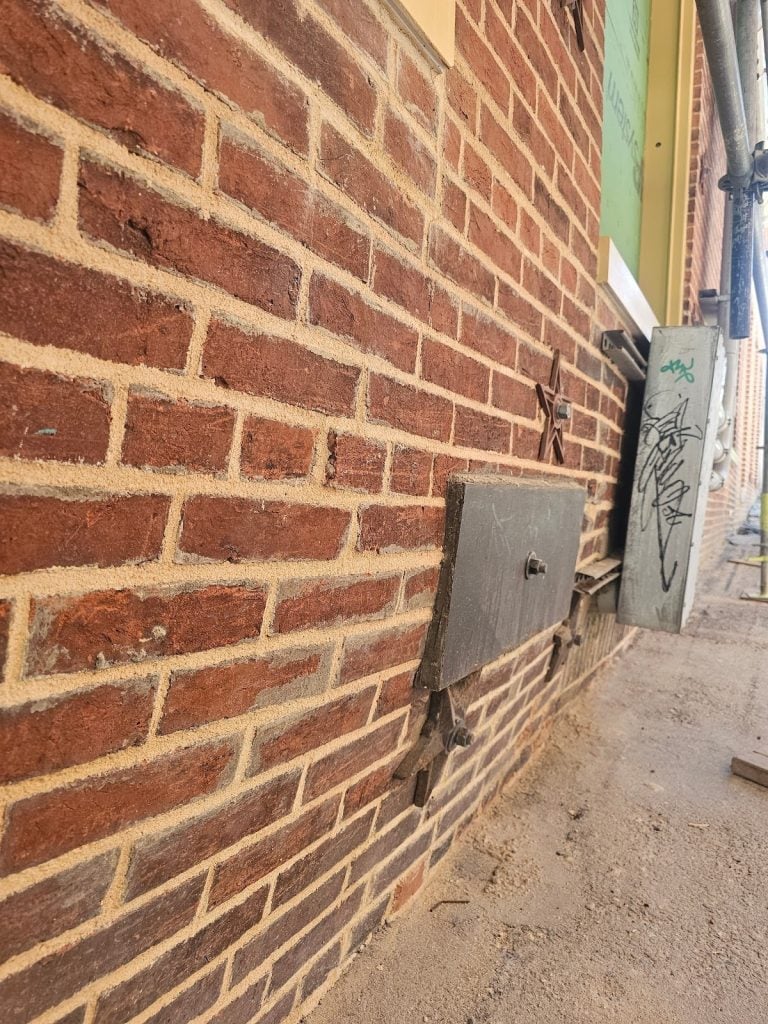 Severe lateral deflection in masonry facade wall structure