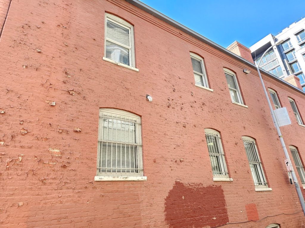 Weathered facade showing cracks in Paint and Mortar Joints