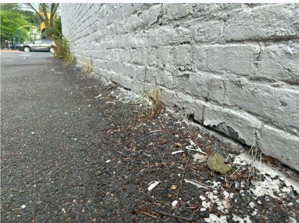 Asphalt pavement termination detail at brick wall connection