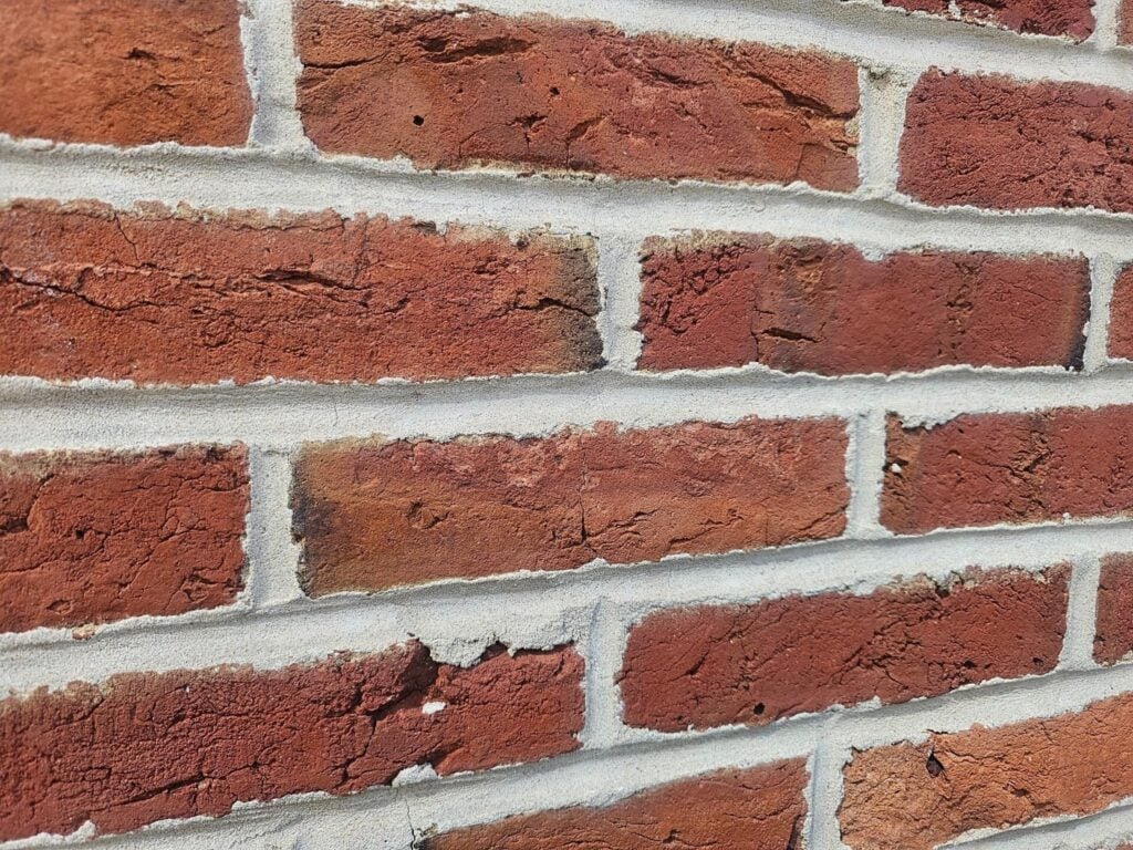 Concave brick mortar joint detail showing smooth weather-resistant finish