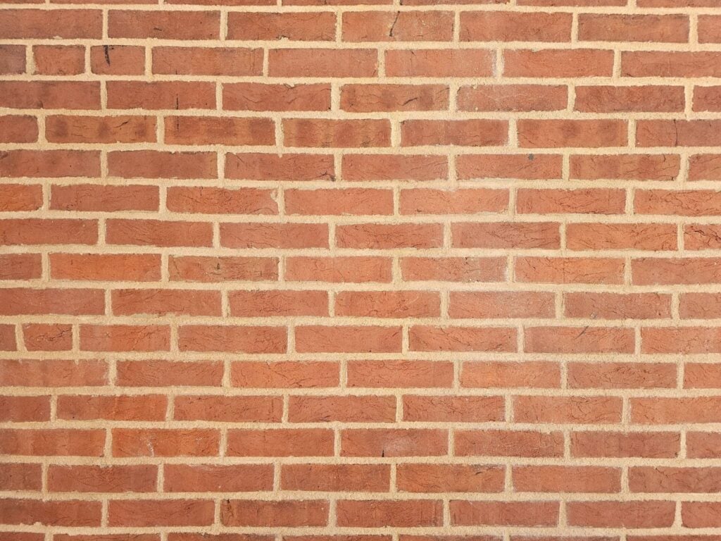 Freshly repointed historic brick wall with restored mortar joints on heritage building