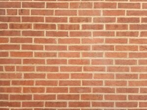 Freshly repointed historic brick wall with restored mortar joints on heritage building