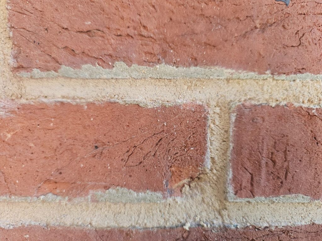 Historic brick wall preservation project with fresh mortar and repaired joints