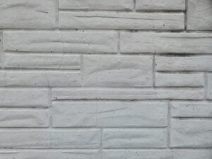 Close-up of formstone applied over historic brick masonry