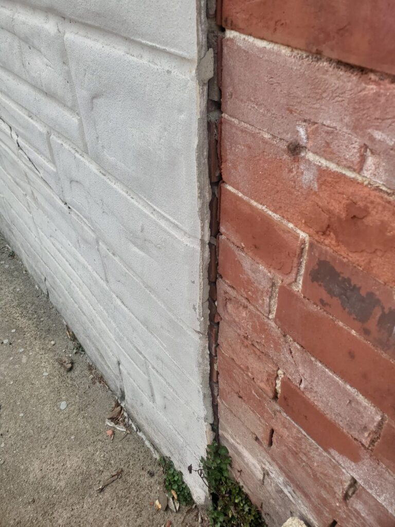 Learning from Other's Masonry Mistakes - Part II 2 cold joint between a formstone-covered historic brick wall and an original historic brick masonry facade